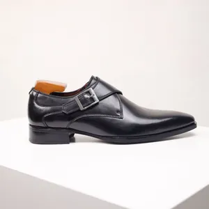 Side view of elegant black leather single monk strap shoe with silver buckle