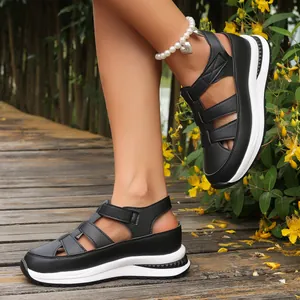 Stylish black women's wedge sandals with hollow design and thick white platform sole