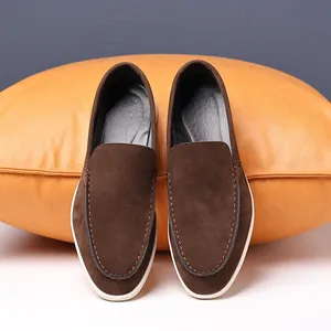 Top view of brown suede loafers for men featuring premium texture and white rubber soles