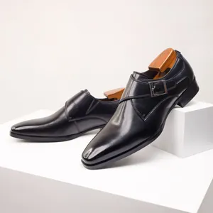 Side view of elegant black leather monk strap shoes with silver buckle and wooden trees