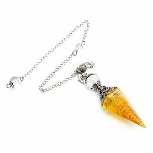 Yellow resin crystal pendulum with hexagonal cone and metal chain detail view