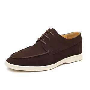Detail shot of dark brown suede lace-up casual shoe with white contrast rubber sole