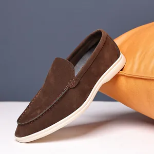Detail view of a premium brown suede loafer with white sole on a minimal background