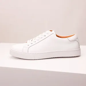Side view of minimalist white leather sneakers with high-quality cowhide texture