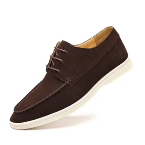 Side view detail of brown suede casual men's shoes with lace-up design and white soles