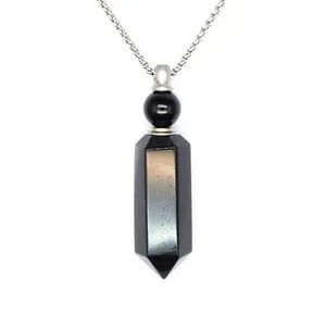 Detailed macro shot of a hexagonal black stone crystal pendant with a sleek silver box chain