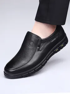 Detailed view of black textured leather men's slip-on loafers with durable rubber sole