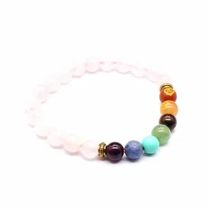 Close-up detail of a natural stone chakra bracelet with 8mm rose quartz beads.