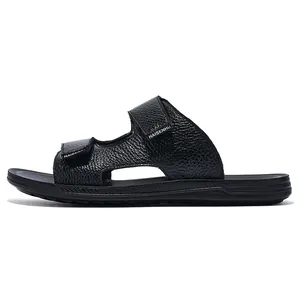 Side view of black men's leather textured slippers with adjustable hook and loop straps