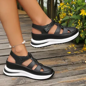 Detail view of black platform wedge sandals with breathable hollow design and velcro straps