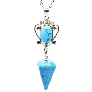 Close-up detail of a vintage turquoise-style pendant necklace with a hexagonal cone stone