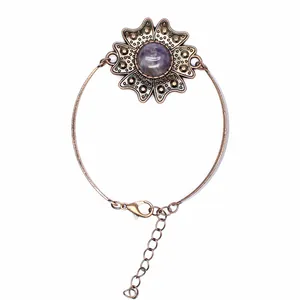 Detailaufnahme eines Vintage-Blumenarmbands aus Bronze mit lila Edelstein und Verschluss
