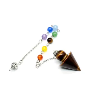 Detail view of a Tiger Eye crystal pendulum with seven colorful chakra beads on chain.