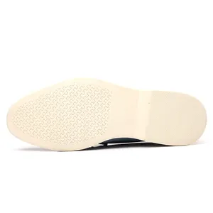 Detailed view of the anti-slip cream sole of a men's blue loafer shoe