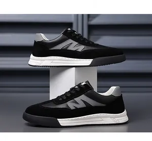 Detailed close-up of retro black and grey leather German trainer sneakers for men.