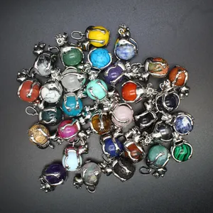 Variety of frog hugging gemstone pendants featuring different natural crystal beads.
