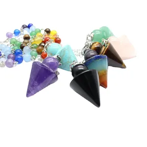 Collection of Seven Chakra healing crystal dowsing pendulums in arrowhead and conical shapes