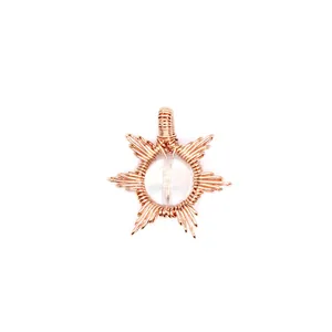 Detailed view of handmade rose gold wire-wrapped sun pendant with clear crystal.