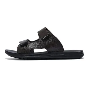 Detailed side view of dark brown textured leather men's slide sandal with dual straps