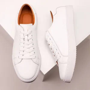 Macro view of premium white leather casual sneakers with thick sole and brown lining