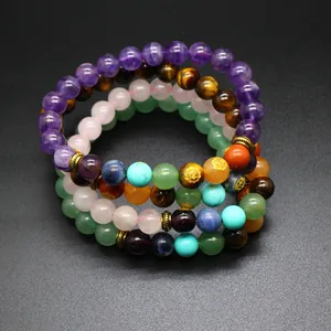Detailed macro view of 8mm natural stone 7-chakra beaded bracelets stacked together