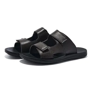 Detailed view of men's brown pebbled leather slippers with non-slip black sole