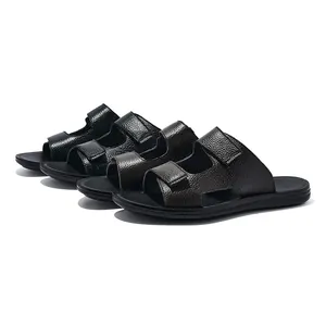 Detailed view of men's pebbled leather slide sandals in black and brown finishes.