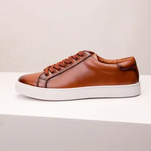 Side profile of brown leather men's casual shoes with thick white soles and laces