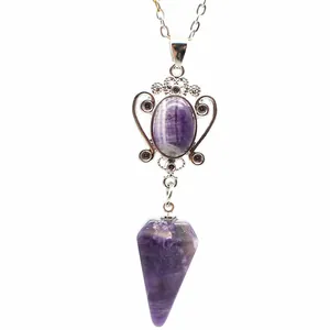 Detail view of a purple amethyst hexagonal cone pendant with silver filigree setting