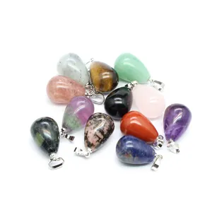 A cluster of colorful natural stone teardrop pendants with silver bails on white