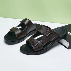 Detail of anti-slip men's brown leather texture slides with adjustable velcro straps.