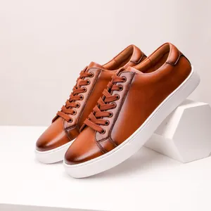 Close-up detail of premium brown leather men's casual sneakers with thick white soles
