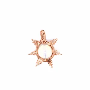 Close-up of handmade rose gold wire wrapped sun pendant with opalite stone