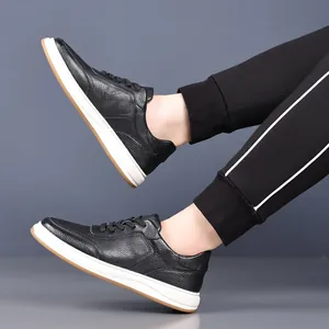 Detailed side view of men's premium black pebbled leather casual sneakers with white soles