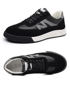 Detailed view of men's black and grey German army trainers with leather suede stitching
