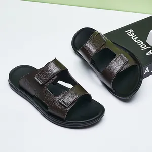 Detailed view of the dark brown pebbled leather texture on these men's summer outdoor slides