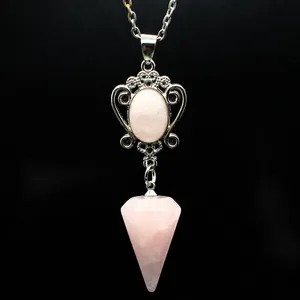 Close-up of pink rose quartz hexagonal cone pendant necklace with silver ornate frame