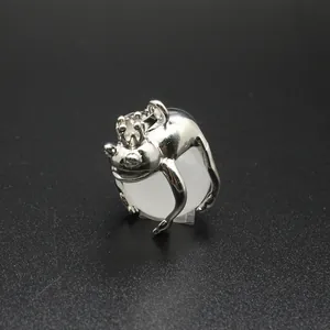 Close-up detail of silver frog prince pendant hugging a round white natural stone bead