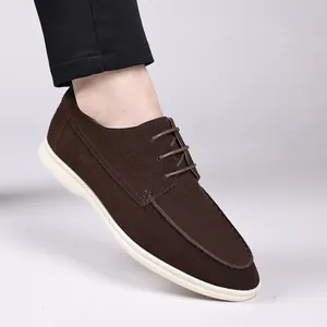Close-up of brown suede lace-up casual shoe with contrast white sole