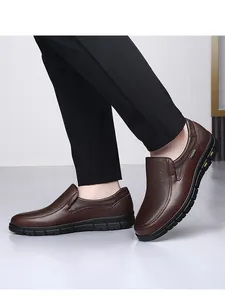Close-up of brown genuine leather loafers highlighting high-quality texture and stitching