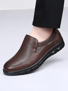 Close-up side view of high-quality brown leather men's slip-on casual shoe being worn