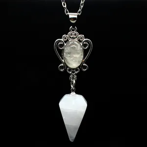 Macro view of natural white crystal hexagonal cone pendant with vintage silver setting