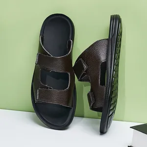Detailed view of brown textured leather men's sandals with black anti-slip soles.