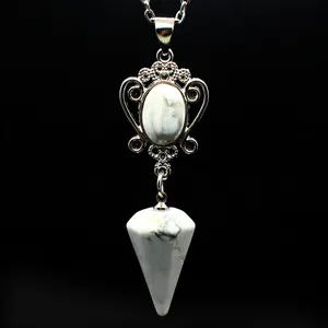 Detail of natural white howlite hexagonal cone pendant necklace with ornate silver frame.