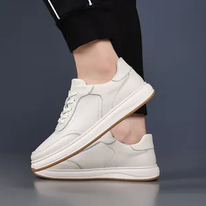 Detailed side view of premium white cowhide leather casual sneakers for men on model