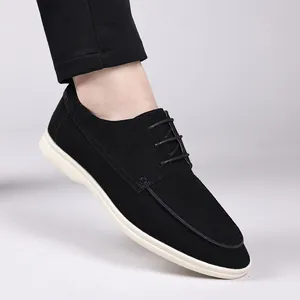 Detailed side view of men's black suede lace-up casual shoes with contrast white soles
