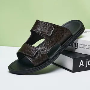 Close-up of dark brown textured leather men's slides showing premium grain detail