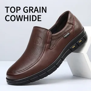 Detailed macro view of the brown leather texture and side profile of a men's loafer