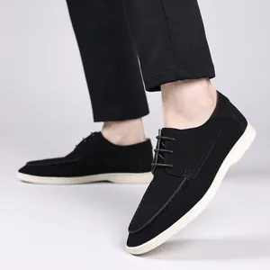 Close-up of men's casual black lace-up shoes with contrast white soles being worn.