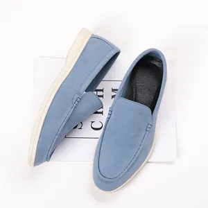 Detailed top view of stylish men's blue suede loafers with comfortable cream soles